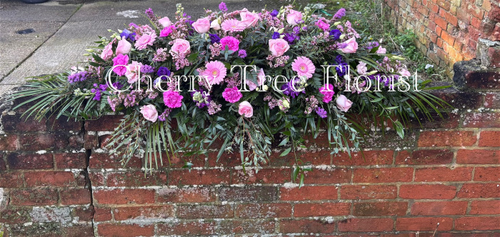 Funerals & Sympathy | Pink and purple spray with trailing foliage