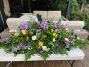 Beautiful casket spray with purples, yellow, blues and whites which compliments this scottish themed funeral spray £250