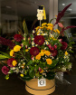 Arrangements | Bouquets | Corporate | Siren's Song: A bold, seductive arrangement of burgundy and yellow flowers presented in a Hat Box