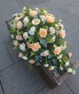 Funeral tributes | Peach, white & cream casket spray