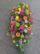 Funeral tributes | Vibrant casket spray